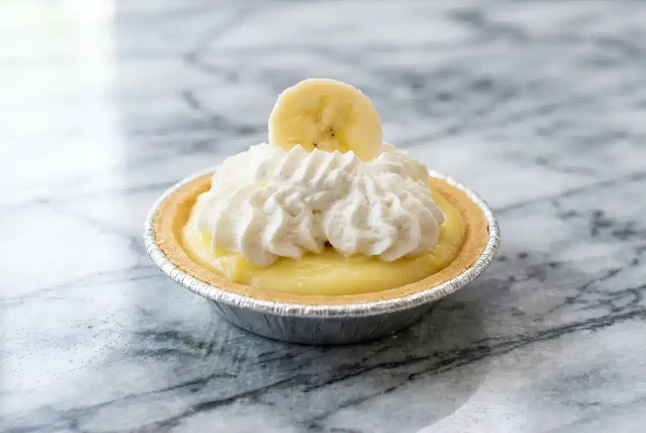 Mini banana cream pies featuring a malted milk chocolate barrier inside a crisp graham cracker crust.