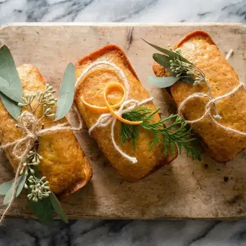 Golden Orange Ginger Honey Cake glistening with a honey-orange simple syrup soak and bits of crystallized ginger.