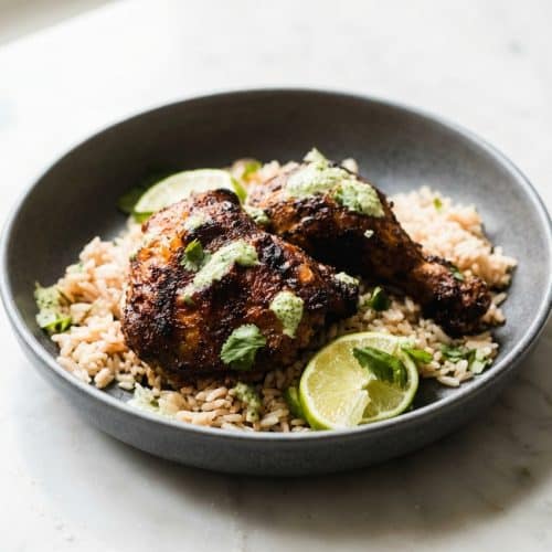 Golden, crispy baked Pollo a la Brasa recipe marinated with Ají Panca and Huacatay, roasted on a wire rack.