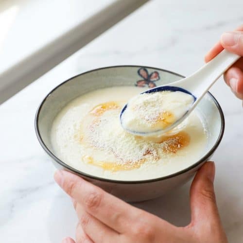 Creamy Ginger Milk Pudding in a bowl, showcasing a thick custard texture achieved through protein-fortification.