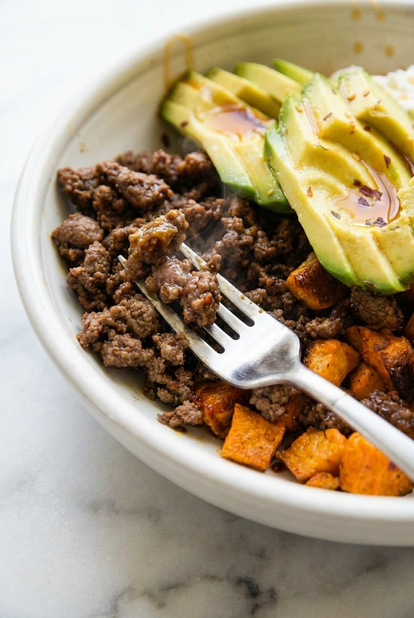 A finished Hot Honey Ground Beef Bowl served in a shallow bowl, highlighting the colorful vegetable toppings.