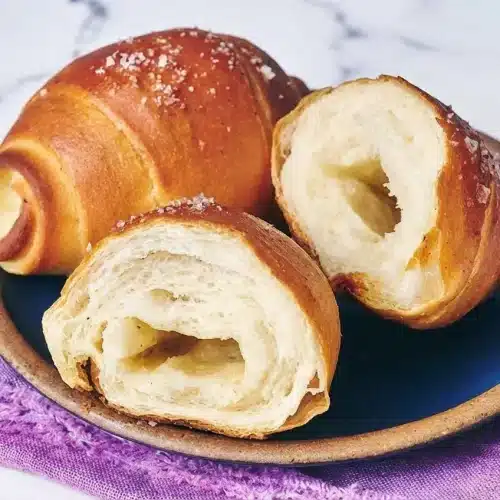 Golden brown Shio Pan Recipe rolls topped with flaky sea salt, made extra soft using a tangzhong and cultured butter hybrid.