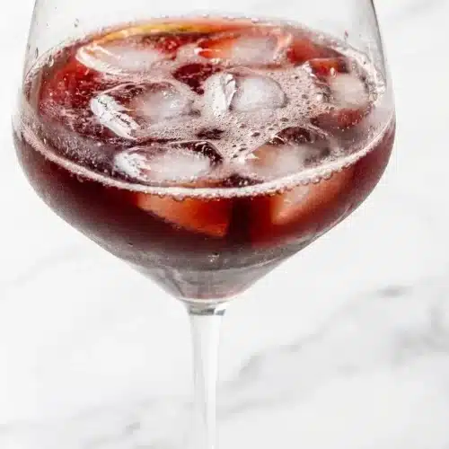 Sleepy girl mocktail recipe in a glass, featuring tart cherry juice infused with steeped chamomile, fresh ginger, and sea salt.