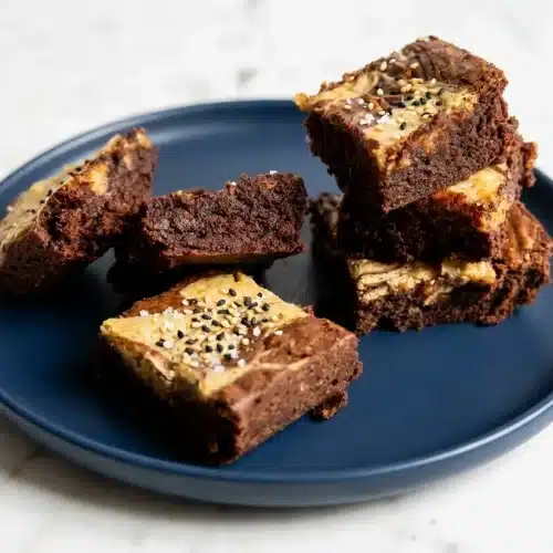 Tahini Swirl Brownies with browned butter and espresso powder, topped with black and white sesame seeds and flaky sea salt.
