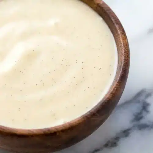Creamy Tahitian Vanilla Sauce Recipe spooned over pan-seared fish, finished with a bright squeeze of lime and mounted butter.