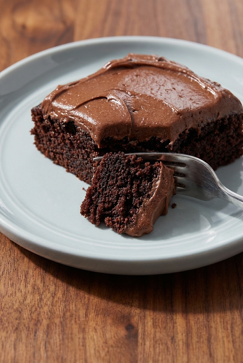 A close-up view showing the incredibly moist and tender crumb of the chocolate mayonnaise cake after being sliced.