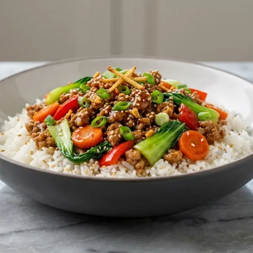 Teriyaki Turkey Rice Bowl topped with crispy ginger-garlic aromatics and fresh green onions.