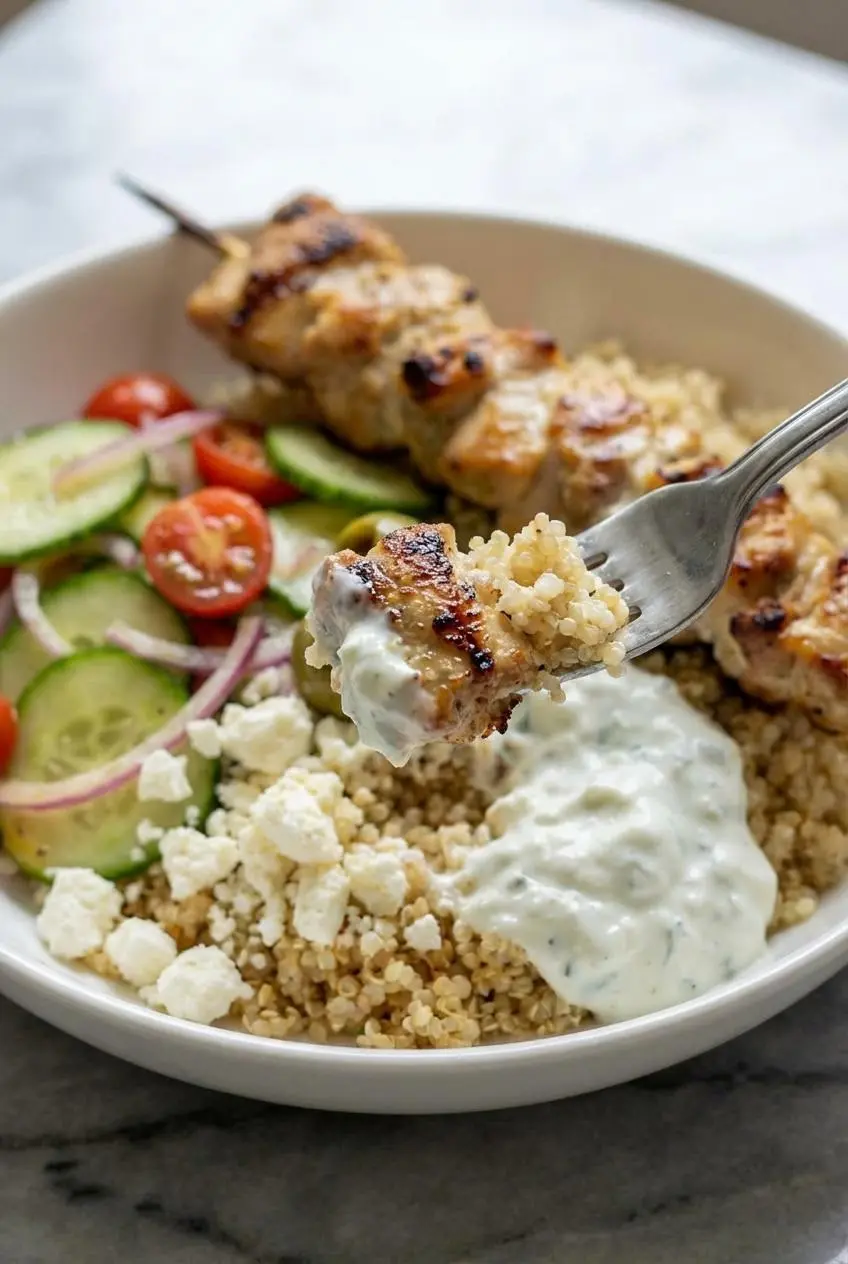 A close-up view of the juicy, spiced chicken pieces piled high in a chicken gyro bowl, ready to be eaten.