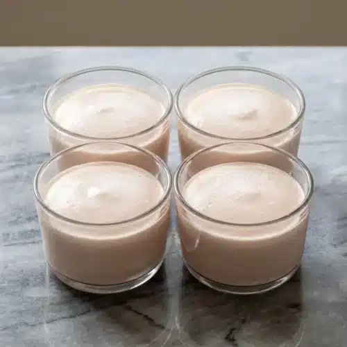A smooth, perfectly set High Protein Jello Mousse in a white ramekin, showing the firm texture achieved by adding extra gelatin.