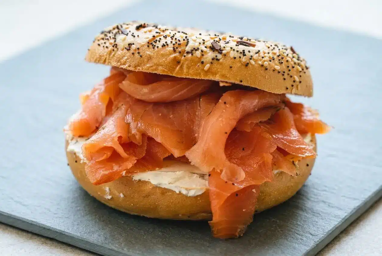 A whole fillet of homemade cold smoked salmon, thinly sliced to reveal its silky, translucent texture.