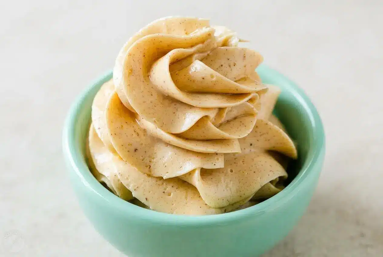 A white bowl filled with creamy, fluffy honey butter made with an easy recipe, ready for spreading on bread.