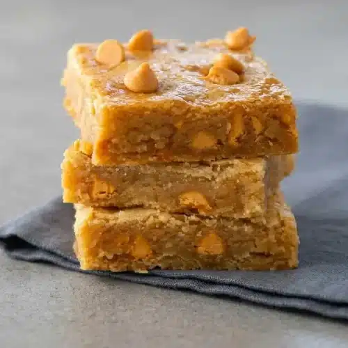 Thick chewy Butterscotch Bars with golden brown edges and a soft matte center baked in a pan.