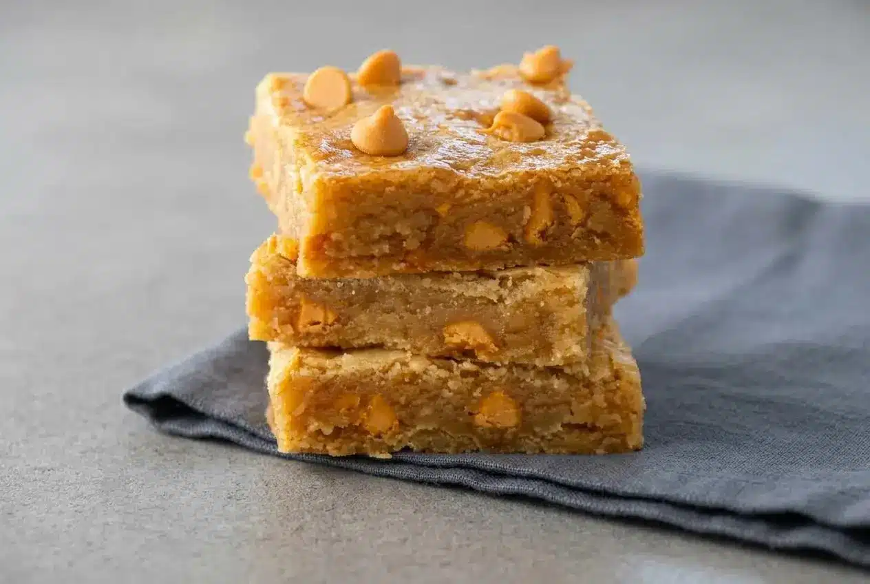 Thick chewy Butterscotch Bars with golden brown edges and a soft matte center baked in a pan.