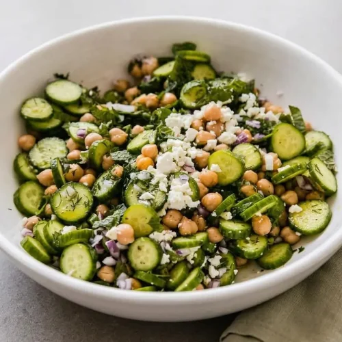 Crisp cucumber chickpea salad with fresh herbs and creamy feta tossed in a bright lemon dressing.