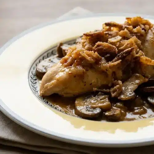 Golden Mushroom Chicken Bake with savory gravy, baby bella mushrooms, and a topping of golden crispy fried onions.