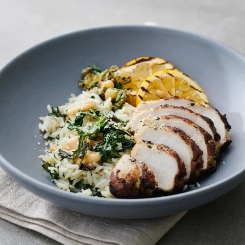 Grilled Chicken Summer Rice Bowls featuring juicy sliced chicken and caramelized lemon over garlicky spinach jasmine rice.