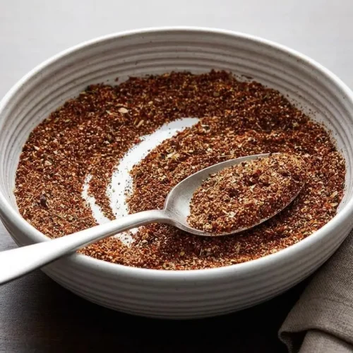 Warm, glossy ground beef seasoned with homemade taco seasoning recipe in a cast iron skillet.