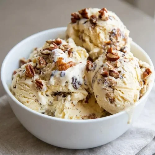 Rich homemade butter pecan ice cream scoop with velvety custard texture and toasted buttered pecans.
