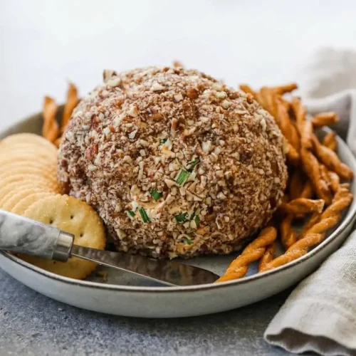 Classic cheese ball recipe featuring a creamy cheddar cheese center coated in crunchy chopped pecans.