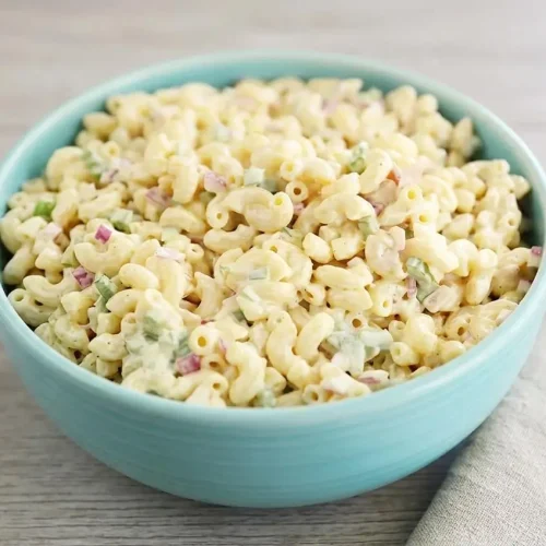 Creamy macaroni salad with elbow pasta, crisp green bell peppers, celery, and red onions in a glossy mayo dressing.