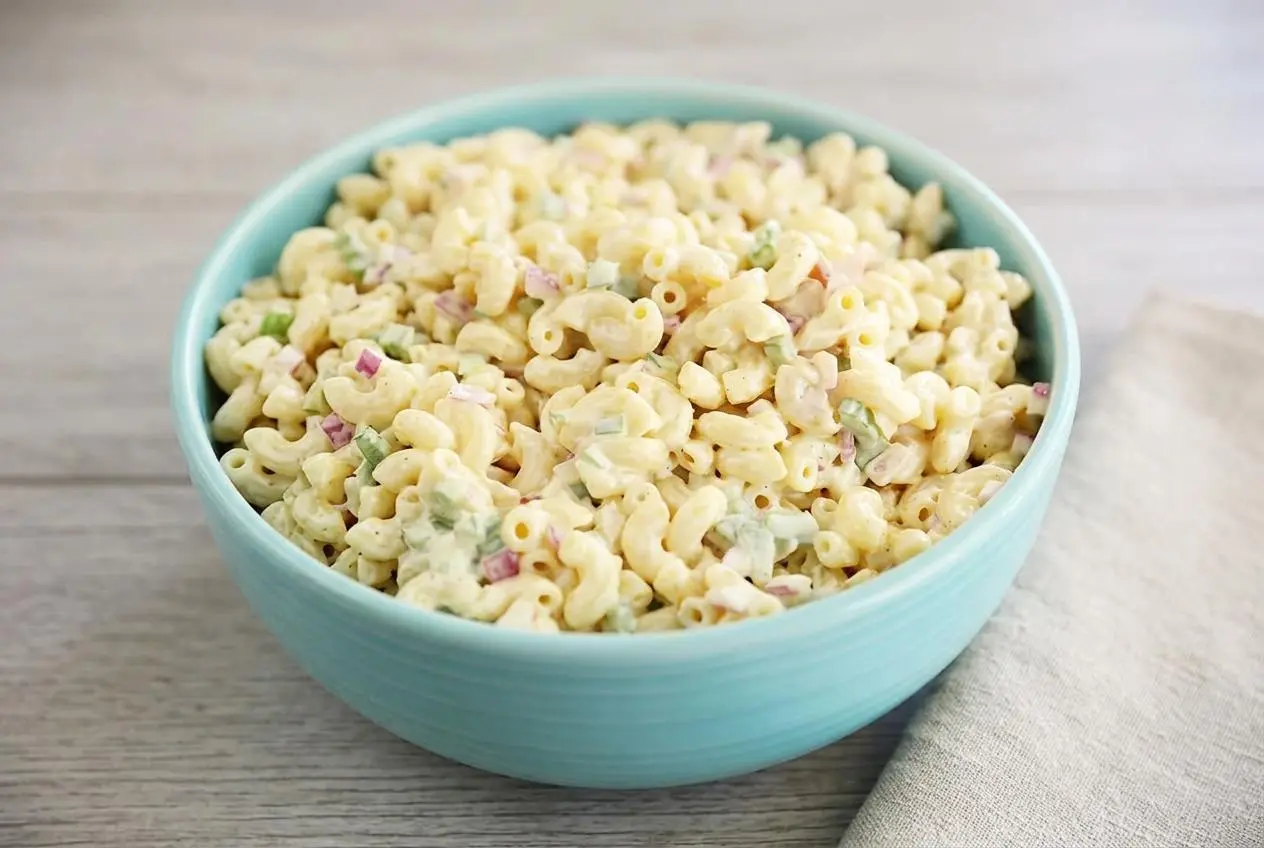 Creamy macaroni salad with elbow pasta, crisp green bell peppers, celery, and red onions in a glossy mayo dressing.