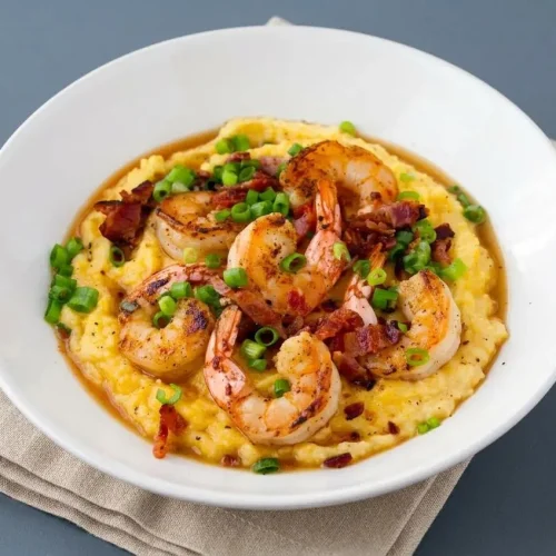Classic shrimp and grits recipe featuring seared jumbo shrimp over creamy cheddar grits with a glossy pan sauce.