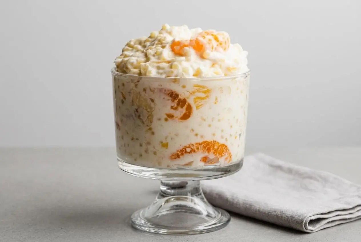 Creamy frog eye salad loaded with tender acini de pepe pasta, mandarin oranges, pineapple, and mini marshmallows.