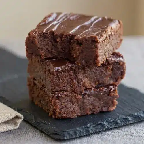 Fudgy sweet potato brownies cut into thick squares with a rich glossy chocolate surface