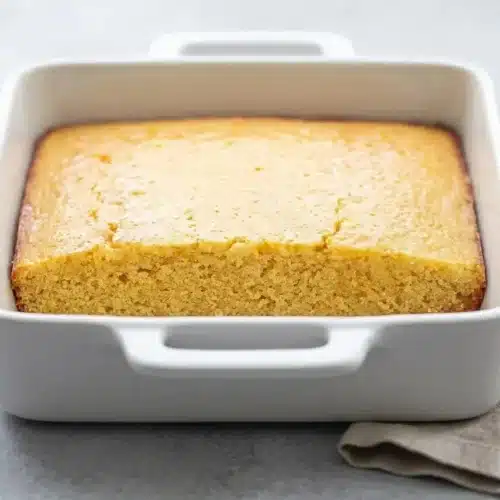 Freshly sliced cornbread recipe featuring a golden baked top, crisp edges, and a tender buttery crumb.