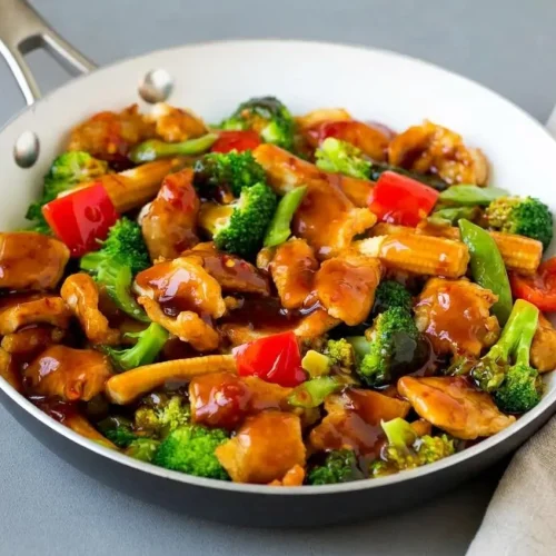 Hunan chicken stir-fry with tender seared chicken and crisp vegetables coated in a glossy chili garlic sauce.