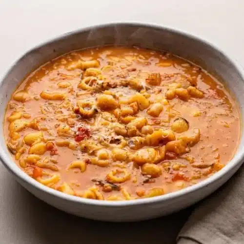 Pasta fagioli recipe with ditalini pasta, cannellini beans, and savory broth topped with grated Parmigiano.