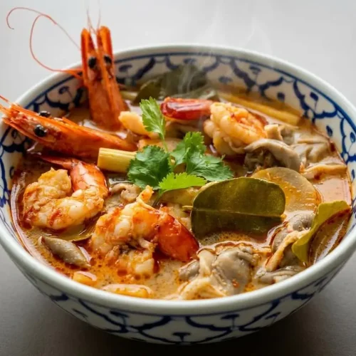 Tom yum soup recipe featuring tender shrimp, aromatic Thai herbs, and chili oil in fragrant broth.