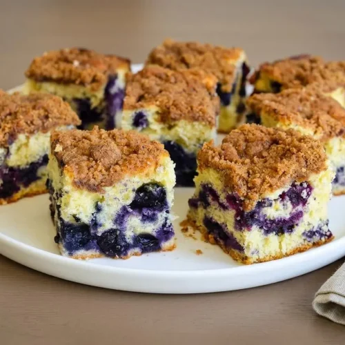 Blueberry coffee cake slice with a golden crumb and crisp cinnamon streusel topping.