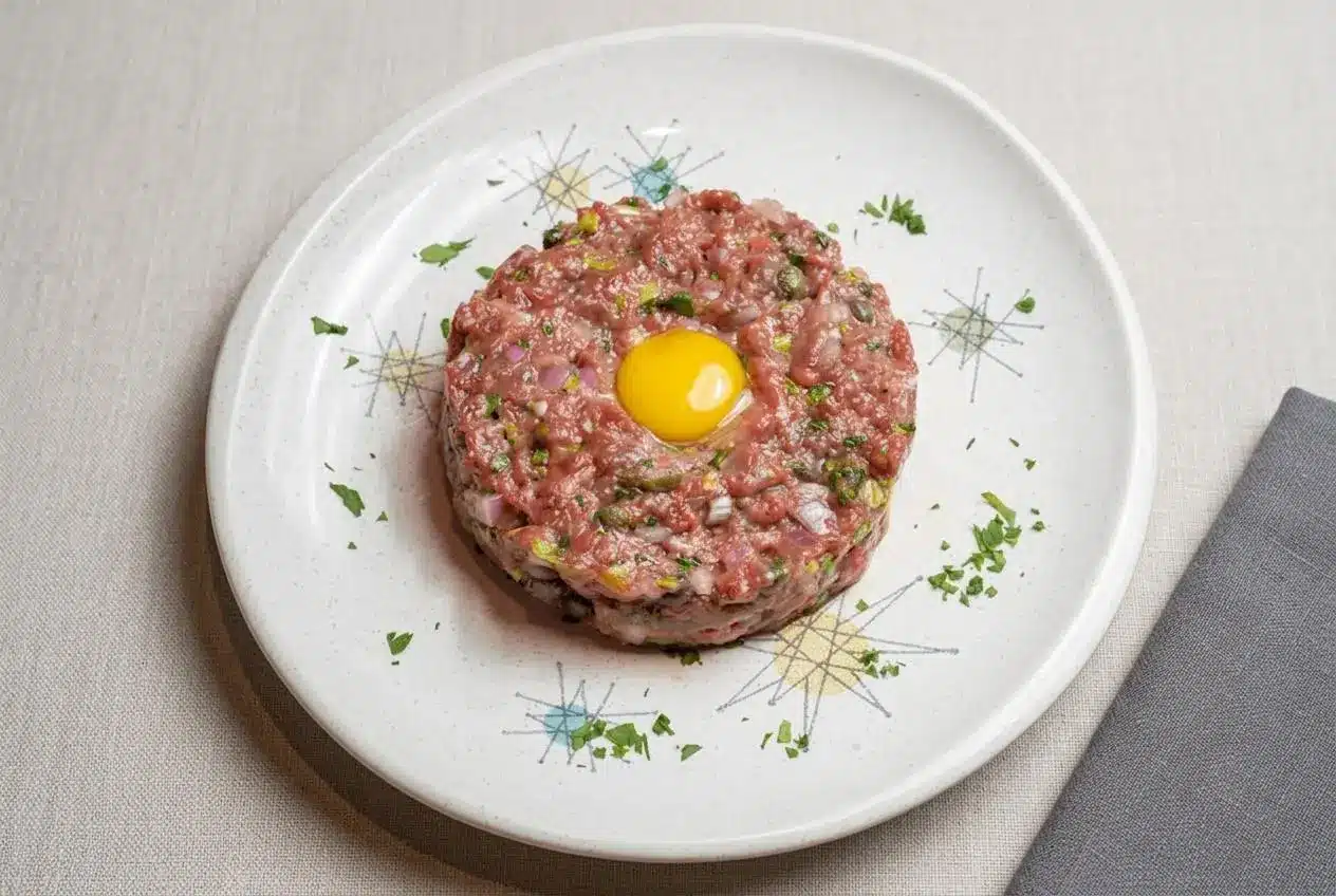 Finely hand-diced beef tartare tossed in a glossy egg yolk dressing with capers and fresh parsley.