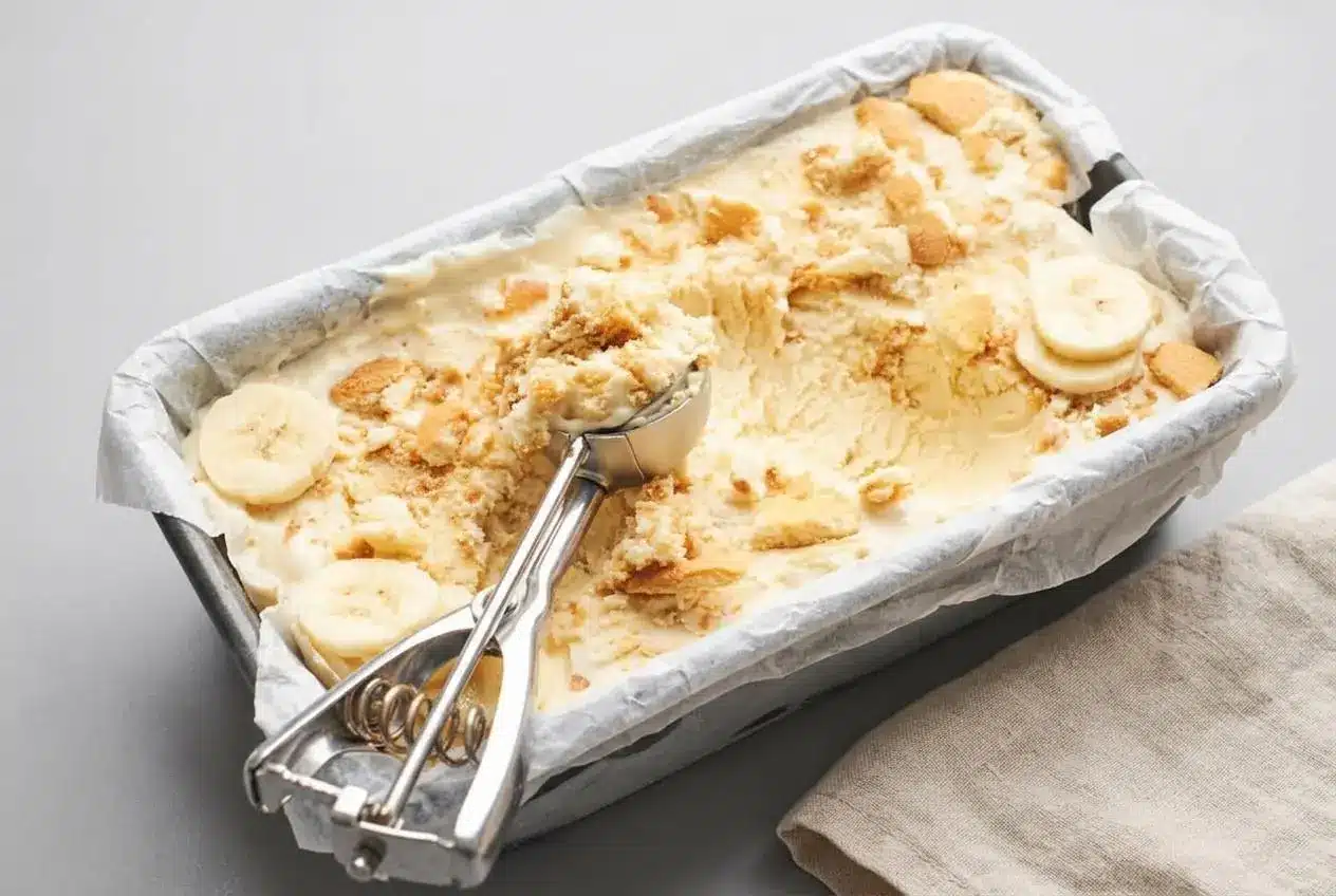 Scoops of creamy banana pudding ice cream loaded with crushed vanilla wafers and soft banana slices.