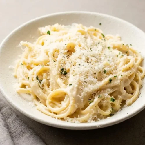 Creamy garlic pasta recipe tossed in a silky parmesan sauce with fresh parsley.