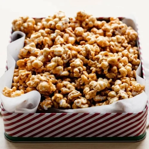 Crisp golden clusters from this homemade caramel corn recipe with a glossy, buttery brown sugar glaze.