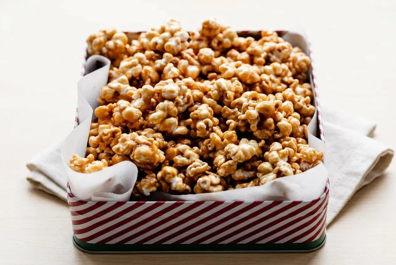 Crisp golden clusters from this homemade caramel corn recipe with a glossy, buttery brown sugar glaze.