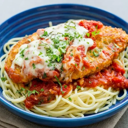 Golden crispy cutlet in this chicken parmesan recipe topped with melted mozzarella cheese and rich marinara sauce.