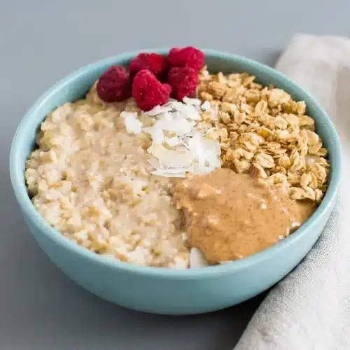 Fluffy egg white oatmeal in a ceramic bowl with a creamy, soft cloud-like finish.