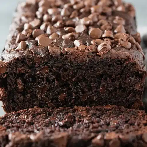 Freshly baked chocolate banana bread loaf studded with melted semisweet chocolate chips and a tender crumb.
