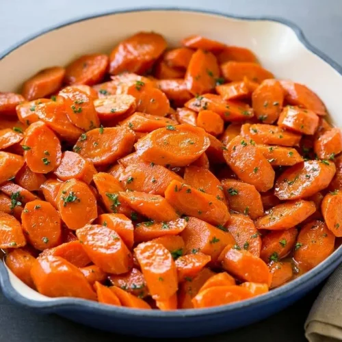 Glazed carrots recipe featuring tender sliced carrot coins coated in a glossy buttery brown sugar sauce.