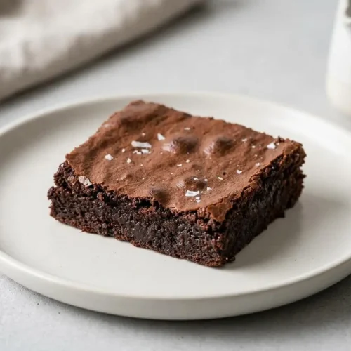 Fudgy gluten free brownie recipe squares with a shiny crackly crust and chewy chocolate centers.