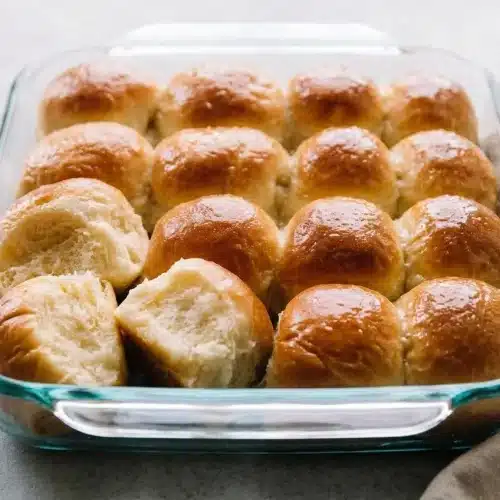 Fluffy baked rolls with a golden crust in a dinner rolls recipe.