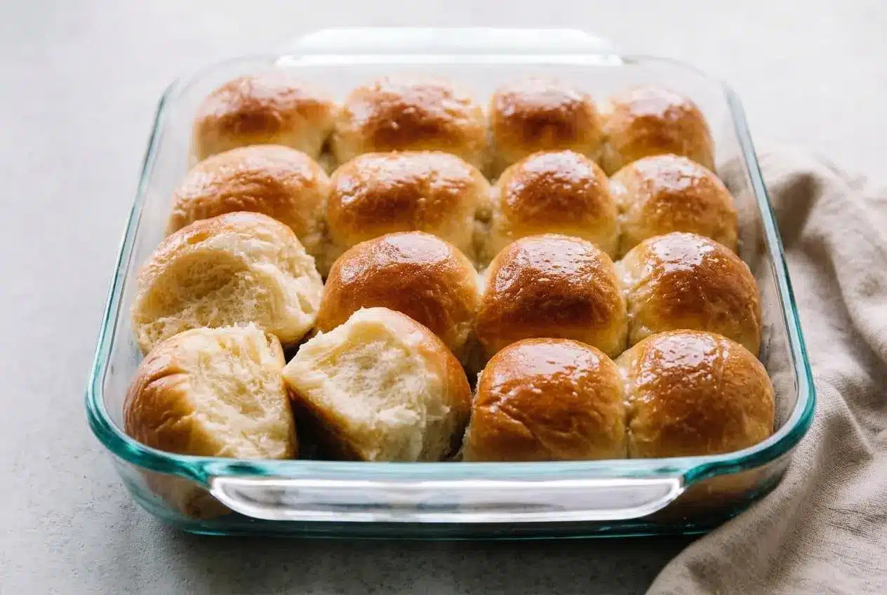 Fluffy baked rolls with a golden crust in a dinner rolls recipe.