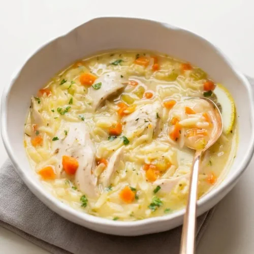 Lemon chicken orzo soup with tender shredded chicken, al dente pasta, and fresh parsley in a velvety golden broth.