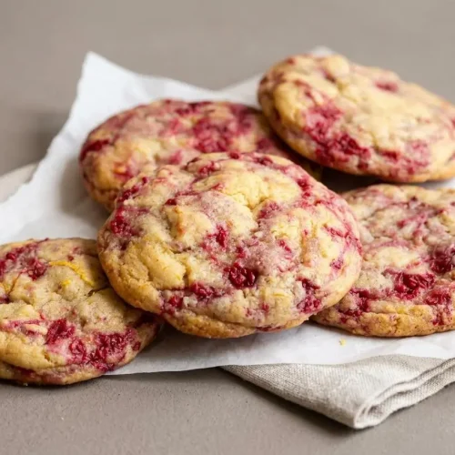 Freshly baked lemon raspberry cookies with lightly golden edges and soft chewy centers.