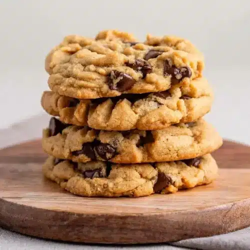 Baked peanut butter chocolate chip cookies with melted chocolate pockets and lightly golden edges.