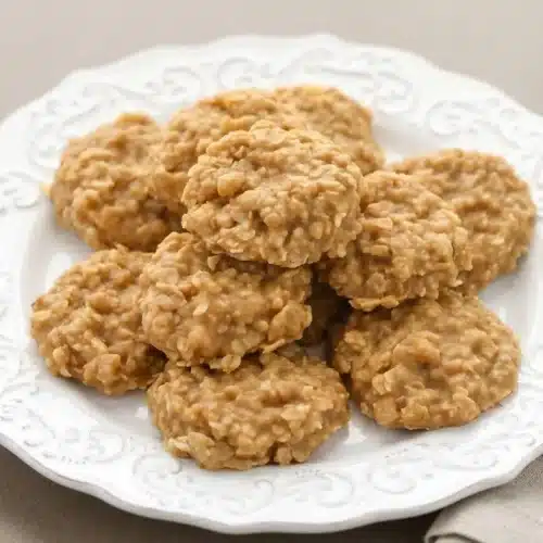 Peanut butter no bake cookies with a fudgy chewy texture and matte set finish on parchment paper.