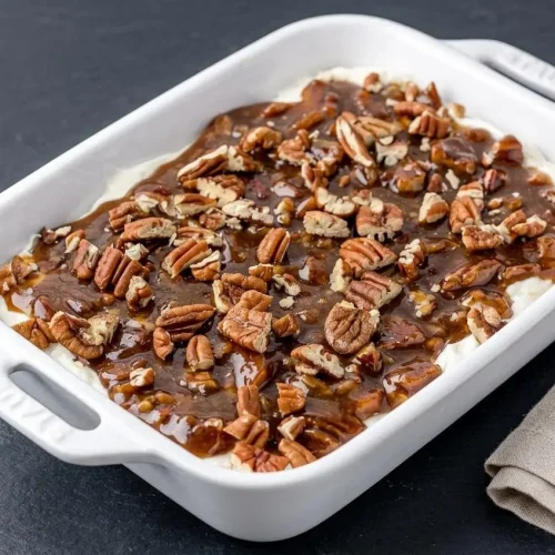 Pecan pie dip layered with fluffy whipped cream cheese and glossy brown sugar pecans.